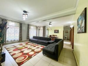 a living room with a couch and a rug at MyPlace Suites in Kigali