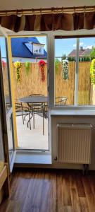 a room with a patio with a table and a view from the door at Penzion Svitavy in Svitavy