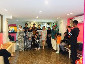 a group of people posing for a picture in a room at Miracle Gallery Hotel in Makkasan