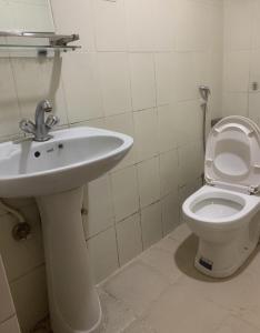 a bathroom with a sink and a toilet at Hotel Brihaspati in Kathmandu