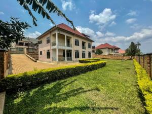 a house with a lawn in front of it at MyPlace Suites in Kigali