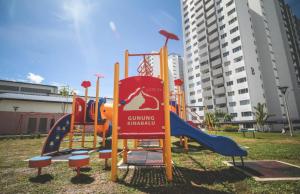 a playground with a slide in a park at Khayla’s Residence in Papar