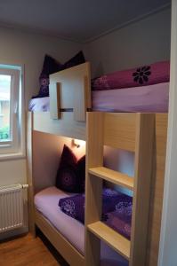 three bunk beds in a room with a window at Mobilheim und Blockhaus mit Seeblick in Sternberg