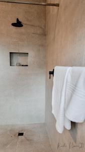 a bathroom with a white towel hanging on a wall at The Aloe in East London