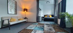 a living room with a couch and a bed at Loft46 - Self Checkin - Long and Shortstay in Berlin