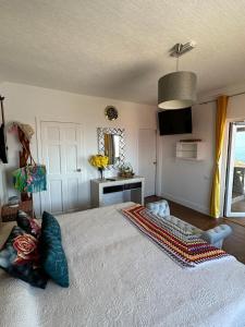 a bedroom with a large bed with pillows on it at Tenerife Sur Habitación de Lujo in Adeje