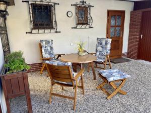 a patio with a wooden table and chairs at Ferienhaus mit Charme DEL in Delmenhorst