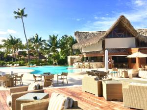 a resort with a pool and tables and chairs at VIK Hotel Cayena Beach All Inclusive in Punta Cana