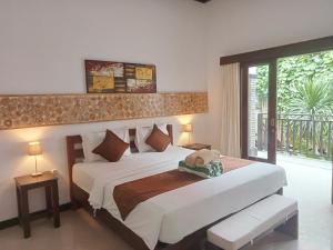 a bedroom with a large bed and a large window at Penida Dream Homestay and hostel in Nusa Penida