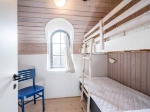 a bedroom with two bunk beds and a window at Holiday home Henne CXXVIII in Henne Strand