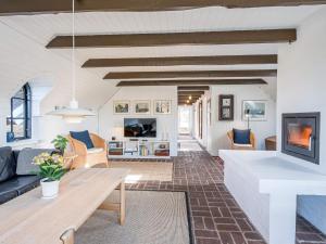 a living room with a couch and a table at Holiday home Henne CXXVIII in Henne Strand