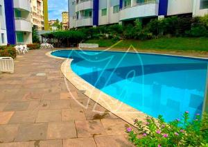 a swimming pool in front of a building at Águas da Serra TURISMO in Rio Quente