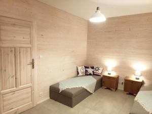 a bedroom with a bed and two night stands at Rybacki Domek 50 metrów do morza! in Dziwnów