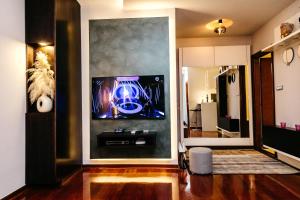 a living room with a tv on a wall at Rosewood Podgorica in Podgorica