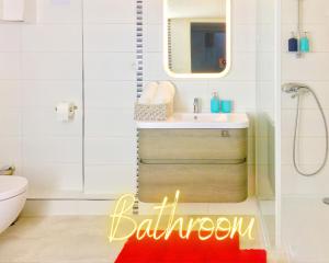 a bathroom with a sink and a red rug at Apartment Duplex with Sauna City- Center Cathedrale in Strasbourg