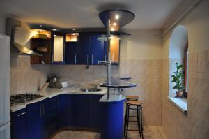 a kitchen with blue cabinets and a sink at Dom w Leśnicy in Leśnica