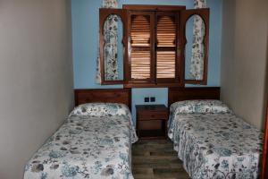 Ένα ή περισσότερα κρεβάτια σε δωμάτιο στο Hotel Maram