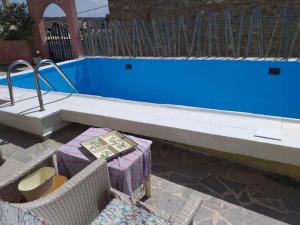 a pool with some boxes in front of it at Cute home Zaros in Zaros
