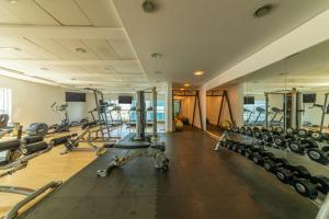 a gym with several treadmills and lots of machines at Exquisite Dubai's Urban Living in the City Centre in Dubai