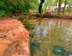 a pool of water with a person in the water at Thermas Paradise - 1 Quarto in Rio Quente