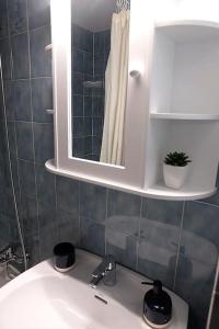 a bathroom with a white sink and a mirror at Apartamento con piscina L' Áncora in Calella de Palafrugell