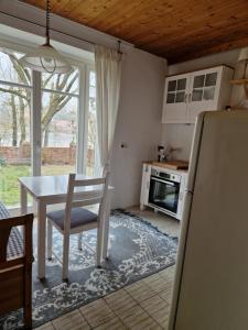a kitchen with a white table and a table and chairs at Ferienwohnung Elbblick in Hohnstorf