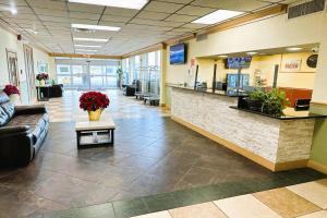 a lobby of a hospital with a couch and a counter at Buckeye Inn near OSU Medical Center, Columbus OH I-71 By OYO in Columbus