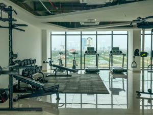a gym with a large window and treadmills at Tim Homestay Nera Garden in Hue