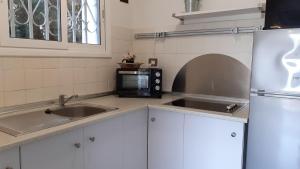 eine Küche mit einer Spüle und einer Mikrowelle in der Unterkunft Apartment Oli - Lloret de Mar in Lloret de Mar