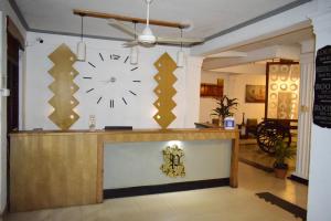 a lobby with a large clock on the wall at Paradise Inn in Kandy