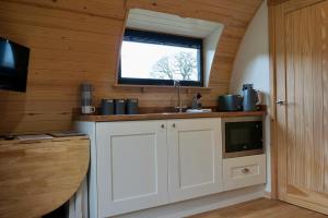 a kitchen with a sink and a window at Habberley Glamping Pods in Shrewsbury