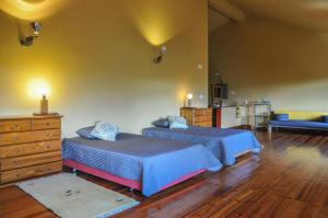 a bedroom with two beds and a dresser at Villa Boa Vista in Madalena
