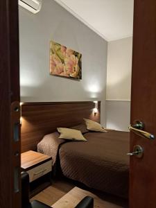 Postel nebo postele na pokoji v ubytování Hotel Leone