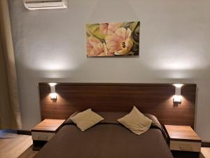 Postel nebo postele na pokoji v ubytování Hotel Leone