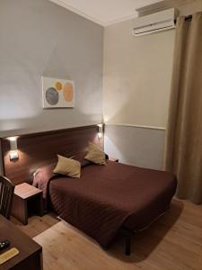 Postel nebo postele na pokoji v ubytování Hotel Leone