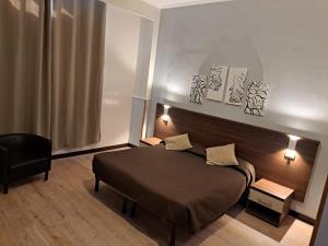 Postel nebo postele na pokoji v ubytování Hotel Leone