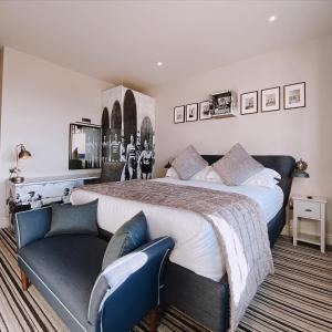 a bedroom with a large bed and a couch at The Woolacombe Bay Hotel in Woolacombe