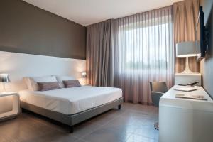 Postel nebo postele na pokoji v ubytování 8Piuhotel