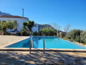 a swimming pool in front of a villa at Appartamento Salvia in Acquedolci