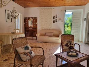 a living room with a couch and chairs and a table at Appartamento Salvia in Acquedolci