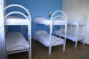 two bunk beds in a room with a blue wall at First Hostel Tropea in Tropea