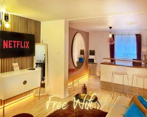 a living room with a netflix sign on the wall at Apartment Duplex with Sauna City- Center Cathedrale in Strasbourg