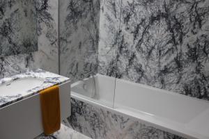 a bathroom with a sink and a bath tub at Groove-Wood Loft in Vila Nova de Gaia +28 photos