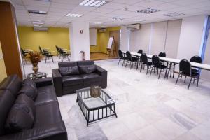 a waiting room with couches and chairs and a table at Like U Hotel Brasília in Brasilia