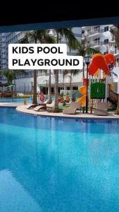 a large swimming pool with a kids pool play ground at SHELL RESIDENCE C9 NEAR AIRPORT & MALL OF ASIA in Manila
