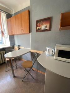 a small kitchen with a table and a microwave at Apartments on Moskovskaja in Dnipro +8 photos