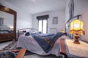 een slaapkamer met een bed met een lamp op een tafel bij Passiflora House - Basilicata in Sant’Angelo
