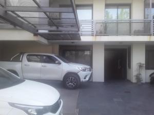 a car parked in a parking lot in front of a house at Mendoza in Mendoza