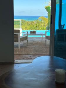 a room with a door open to a view of the ocean at Piece of Paradise in Las Terrenas