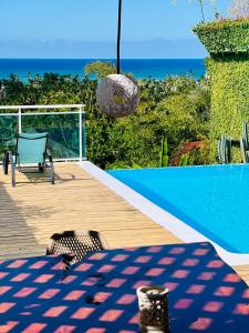 a deck with a pool and a table and a chair at Piece of Paradise in Las Terrenas